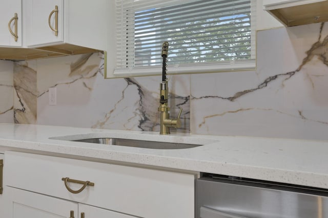 1676 Parsons Ave, Columbus, OH 43207 - kitchen featuring a sink, stainless steel dishwasher, tasteful backsplash, and white cabinetry