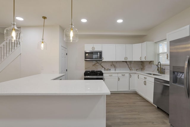 1676 Parsons Ave, Columbus, OH 43207 - kitchen featuring stainless steel appliances, a sink, tasteful backsplash, recessed lighting, and white cabinetry