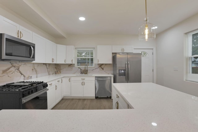 1676 Parsons Ave, Columbus, OH 43207 - kitchen featuring appliances with stainless steel finishes, healthy amount of natural light, a sink, white cabinets, and recessed lighting