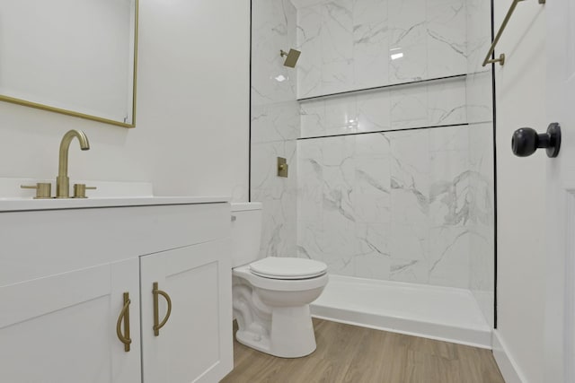 1676 Parsons Ave, Columbus, OH 43207 - bathroom featuring toilet, vanity, a marble finish shower, and wood finished floors