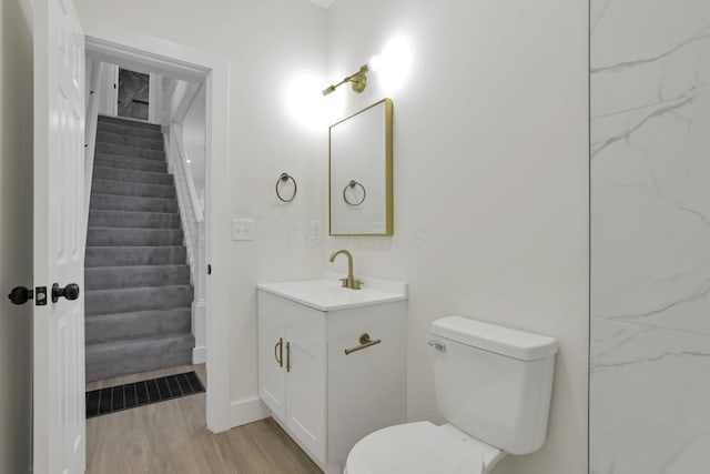 1676 Parsons Ave, Columbus, OH 43207 - bathroom with vanity, toilet, and wood finished floors