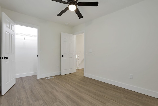 1676 Parsons Ave, Columbus, OH 43207 - unfurnished bedroom featuring baseboards, wood finished floors, ceiling fan, and a closet