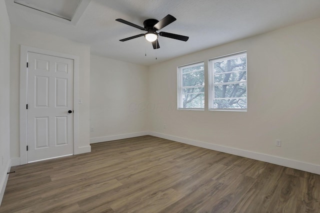 1676 Parsons Ave, Columbus, OH 43207 - empty room with wood finished floors, baseboards, a ceiling fan, and attic access