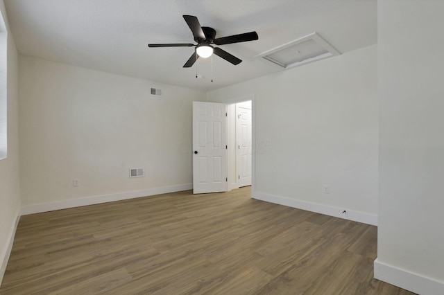 1676 Parsons Ave, Columbus, OH 43207 - unfurnished room featuring attic access, wood finished floors, baseboards, and ceiling fan