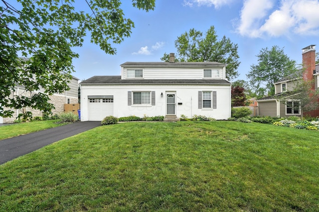 2079 Inchcliff Rd, Upper Arlington, OH 43221 - traditional-style house with a garage, driveway, a chimney, and a front yard