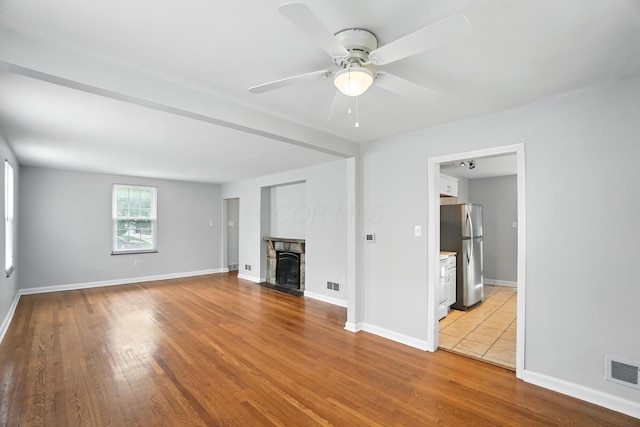 2079 Inchcliff Rd, Upper Arlington, OH 43221 - unfurnished living room with wood finished floors, a ceiling fan, and a fireplace