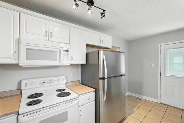 2079 Inchcliff Rd, Upper Arlington, OH 43221 - kitchen featuring white appliances, white cabinetry, light tile patterned flooring, light countertops, and a textured ceiling