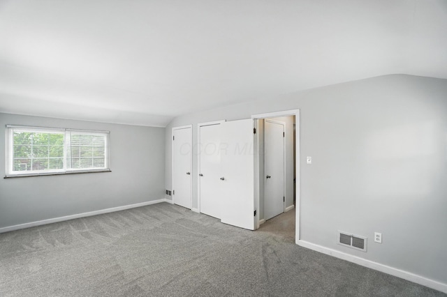 2079 Inchcliff Rd, Upper Arlington, OH 43221 - unfurnished bedroom with vaulted ceiling, carpet flooring, and multiple closets