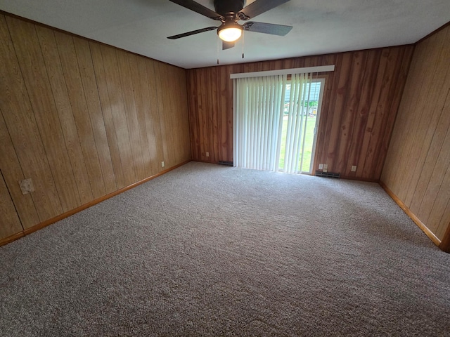 405 E 5th St, West Lafayette, OH 43845 - carpeted empty room with a ceiling fan, wooden walls, and baseboards