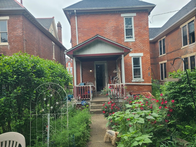 688 S Ohio Ave, Columbus, OH 43205 - view of front of home with a porch, brick siding, and a shingled roof