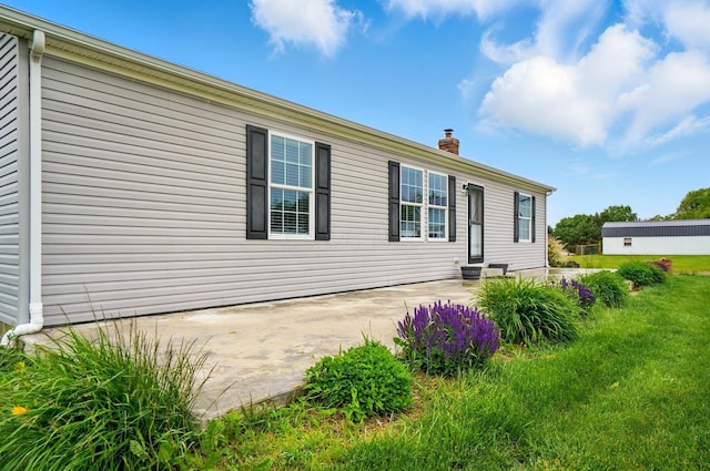9842 State Route 757 NW, Somerset, OH 43783 - back of property with a patio area, a chimney, and a yard