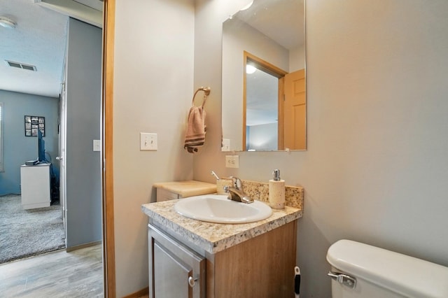 9842 State Route 757 NW, Somerset, OH 43783 - bathroom with vanity, wood finished floors, and toilet