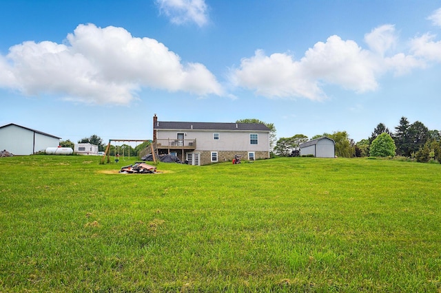 9842 State Route 757 NW, Somerset, OH 43783 - rear view of house featuring a deck, a yard, a chimney, and an outbuilding