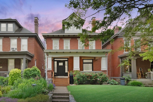 663 Wilson Ave, Columbus, OH 43205 - american foursquare style home featuring a lawn and brick siding