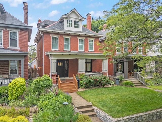 663 Wilson Ave, Columbus, OH 43205 - american foursquare style home with a porch, brick siding, a front yard, and a chimney