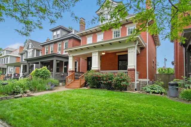 663 Wilson Ave, Columbus, OH 43205 - traditional style home with brick siding, covered porch, a front yard, and a chimney