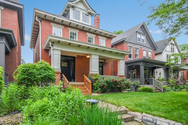 663 Wilson Ave, Columbus, OH 43205 - american foursquare style home featuring a porch, brick siding, and a front lawn