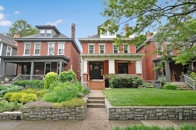 663 Wilson Ave, Columbus, OH 43205 - american foursquare style home with a porch, brick siding, a front yard, and a chimney