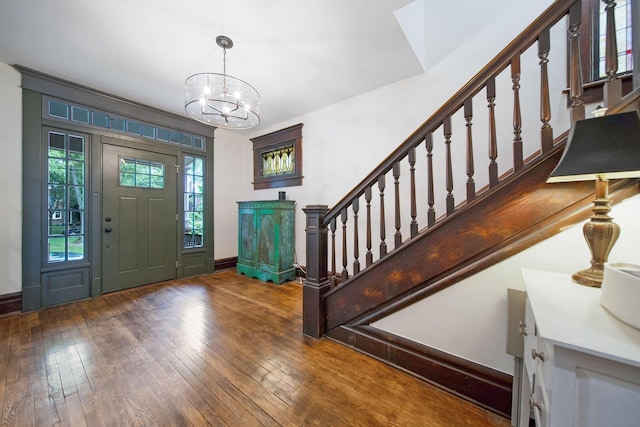 663 Wilson Ave, Columbus, OH 43205 - foyer entrance with a chandelier, hardwood / wood-style flooring, stairway, and baseboards
