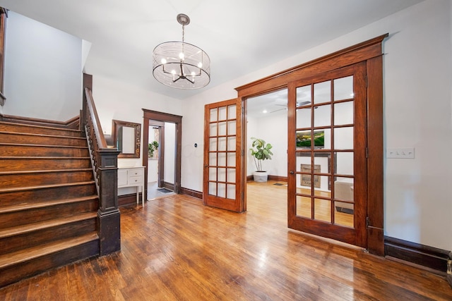 663 Wilson Ave, Columbus, OH 43205 - foyer entrance featuring french doors, a chandelier, wood finished floors, and stairway