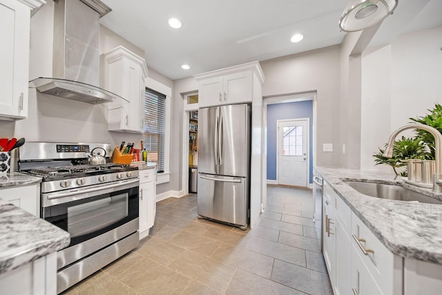 663 Wilson Ave, Columbus, OH 43205 - kitchen featuring appliances with stainless steel finishes, wall chimney exhaust hood, a sink, white cabinetry, and light stone countertops