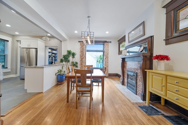 663 Wilson Ave, Columbus, OH 43205 - dining room featuring light wood-type flooring, a fireplace with flush hearth, baseboards, and recessed lighting