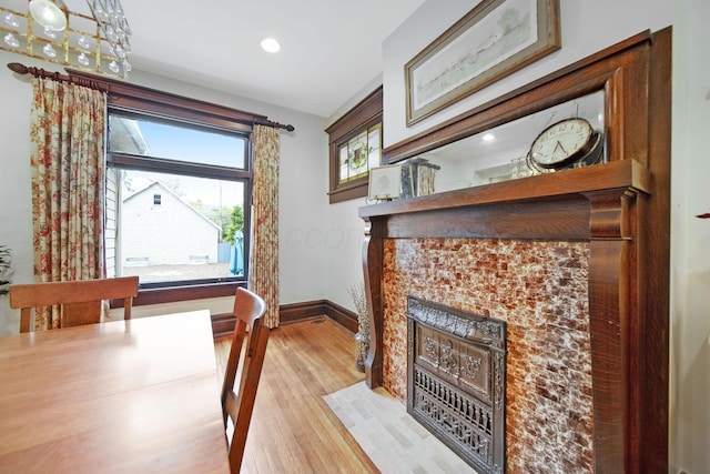 663 Wilson Ave, Columbus, OH 43205 - dining area with light wood-type flooring, baseboards, a fireplace with flush hearth, and recessed lighting