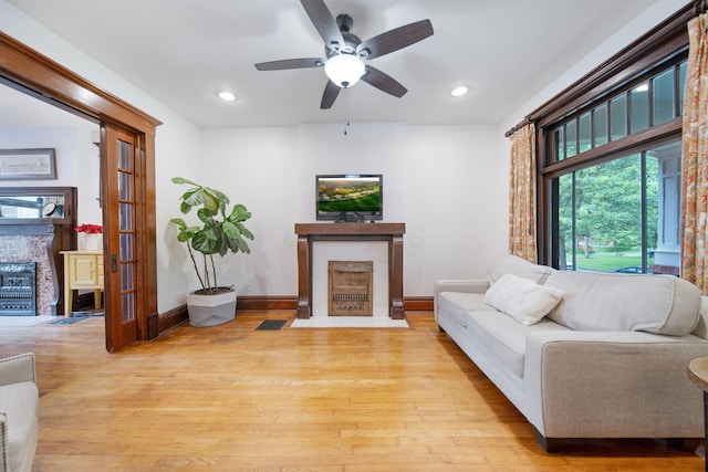 663 Wilson Ave, Columbus, OH 43205 - living room featuring a brick fireplace, a ceiling fan, wood finished floors, baseboards, and recessed lighting