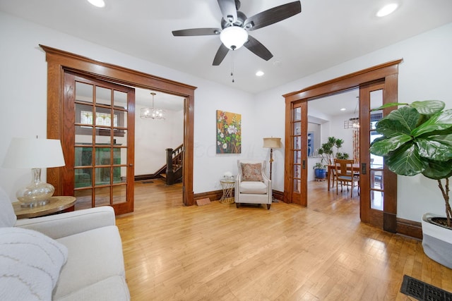 663 Wilson Ave, Columbus, OH 43205 - living room featuring light wood finished floors, baseboards, french doors, recessed lighting, and a chandelier