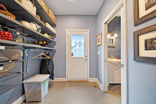 663 Wilson Ave, Columbus, OH 43205 - mudroom with a sink, baseboards, and tile patterned flooring
