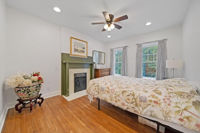 663 Wilson Ave, Columbus, OH 43205 - bedroom with wood finished floors, baseboards, a fireplace with flush hearth, recessed lighting, and a ceiling fan