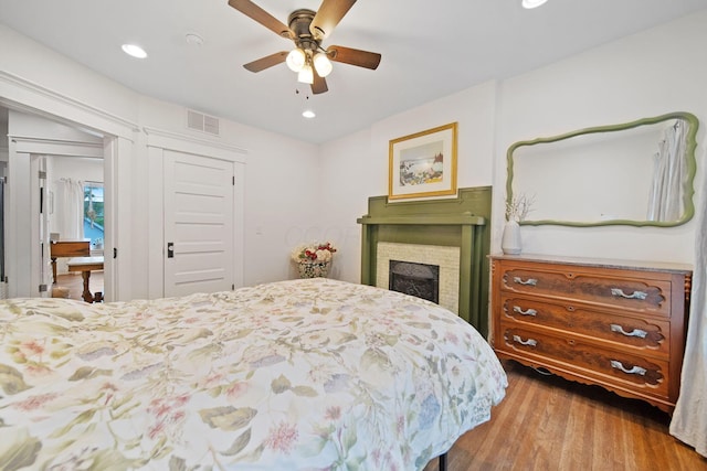 663 Wilson Ave, Columbus, OH 43205 - bedroom with wood finished floors, a closet, recessed lighting, a fireplace, and ceiling fan