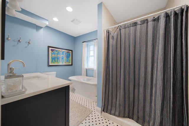 663 Wilson Ave, Columbus, OH 43205 - bathroom featuring a freestanding tub, vanity, a shower with shower curtain, and recessed lighting