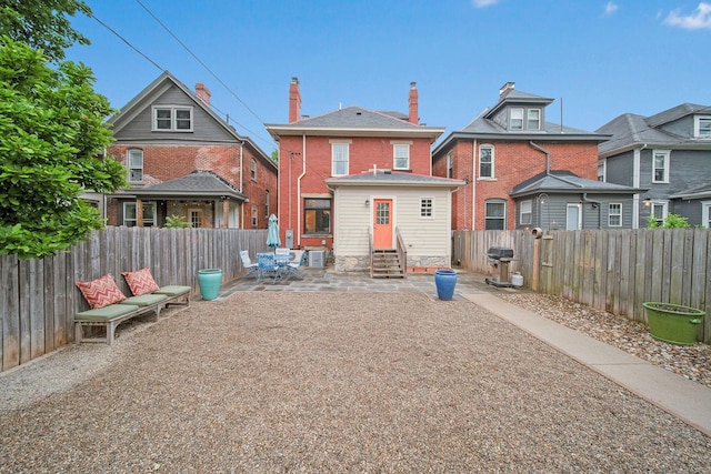 663 Wilson Ave, Columbus, OH 43205 - rear view of property featuring entry steps, a fenced backyard, and a patio area