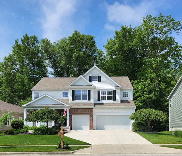 7313 Bromfield Dr, Canal Winchester, OH 43110 - view of front of house with a garage, concrete driveway, a front yard, and brick siding