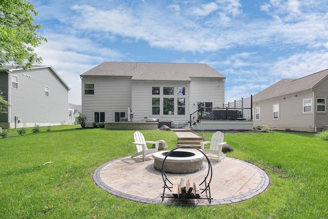 7313 Bromfield Dr, Canal Winchester, OH 43110 - rear view of property featuring a fire pit, a patio area, a lawn, and a wooden deck