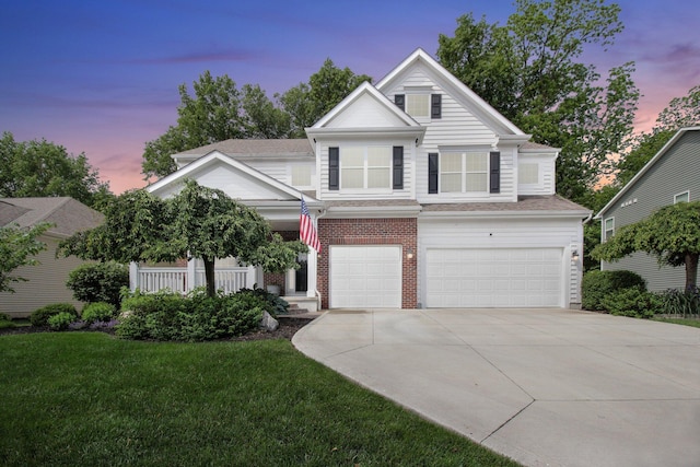 7313 Bromfield Dr, Canal Winchester, OH 43110 - view of front of home with a garage, driveway, a yard, brick siding, and covered porch