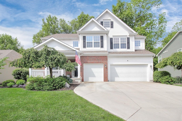 7313 Bromfield Dr, Canal Winchester, OH 43110 - view of front of house featuring a garage, driveway, a front lawn, and brick siding