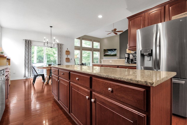 7313 Bromfield Dr, Canal Winchester, OH 43110 - kitchen with stainless steel fridge with ice dispenser, healthy amount of natural light, dark wood finished floors, a kitchen island, and recessed lighting