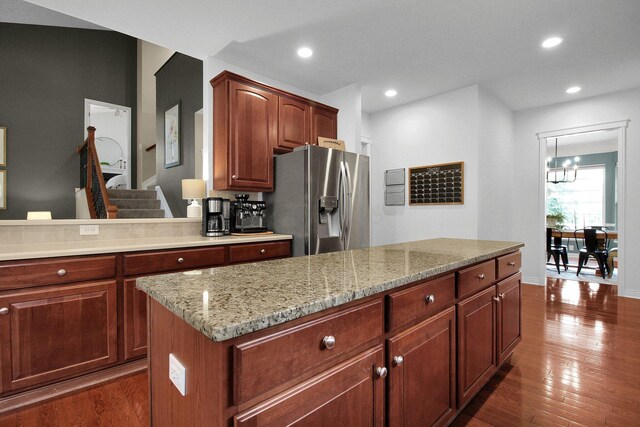 7313 Bromfield Dr, Canal Winchester, OH 43110 - kitchen featuring stainless steel fridge with ice dispenser, a chandelier, dark wood-style flooring, light stone countertops, and recessed lighting