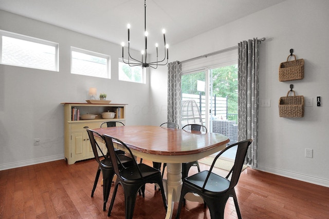 7313 Bromfield Dr, Canal Winchester, OH 43110 - dining area with a chandelier, wood finished floors, and baseboards