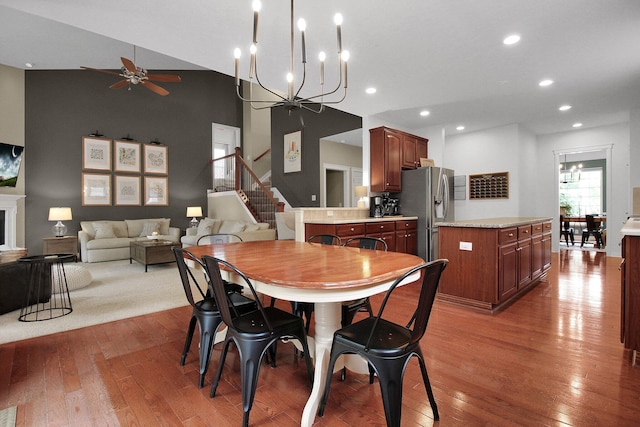 7313 Bromfield Dr, Canal Winchester, OH 43110 - dining room with a chandelier, ceiling fan, hardwood / wood-style floors, a high ceiling, and recessed lighting