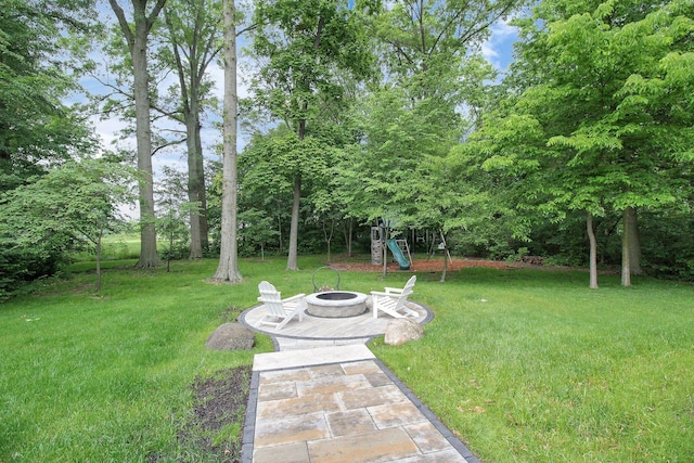 7313 Bromfield Dr, Canal Winchester, OH 43110 - view of green lawn featuring a fire pit and a playground