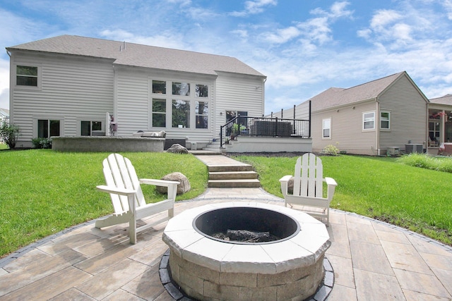 7313 Bromfield Dr, Canal Winchester, OH 43110 - rear view of property featuring an outdoor fire pit, a patio area, a deck, and a lawn