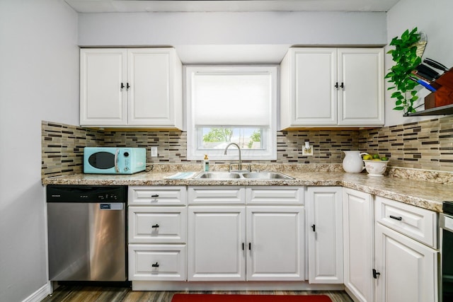 4351 Broadhurst Dr, Columbus, OH 43213 - kitchen featuring dishwasher, a sink, white microwave, white cabinetry, and tasteful backsplash