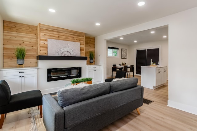143 S Princeton Ave, Columbus, OH 43222 - living area featuring baseboards, light wood-style floors, recessed lighting, and a glass covered fireplace