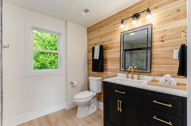 143 S Princeton Ave, Columbus, OH 43222 - bathroom featuring wood walls, toilet, vanity, baseboards, and wood finished floors