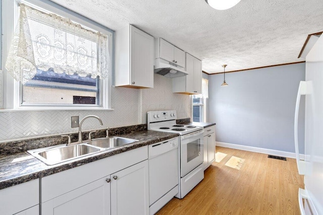 644 Eastmoor Blvd, Columbus, OH 43209 - kitchen with white appliances, a sink, dark countertops, light wood-type flooring, and under cabinet range hood
