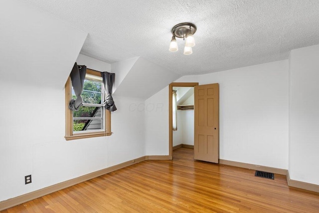 644 Eastmoor Blvd, Columbus, OH 43209 - bonus room with baseboards, light wood-type flooring, and a textured ceiling