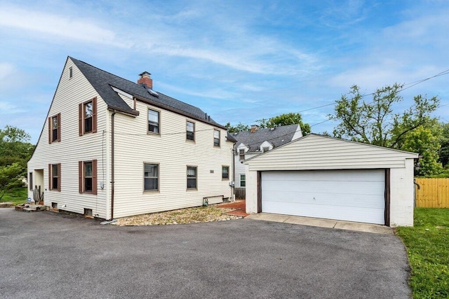 644 Eastmoor Blvd, Columbus, OH 43209 - view of property exterior featuring a chimney, an outdoor structure, and a garage